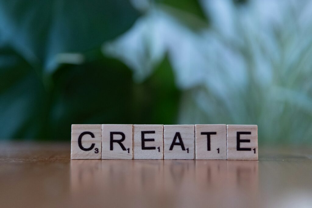 Wooden letter tiles spelling the word CREATE on a table