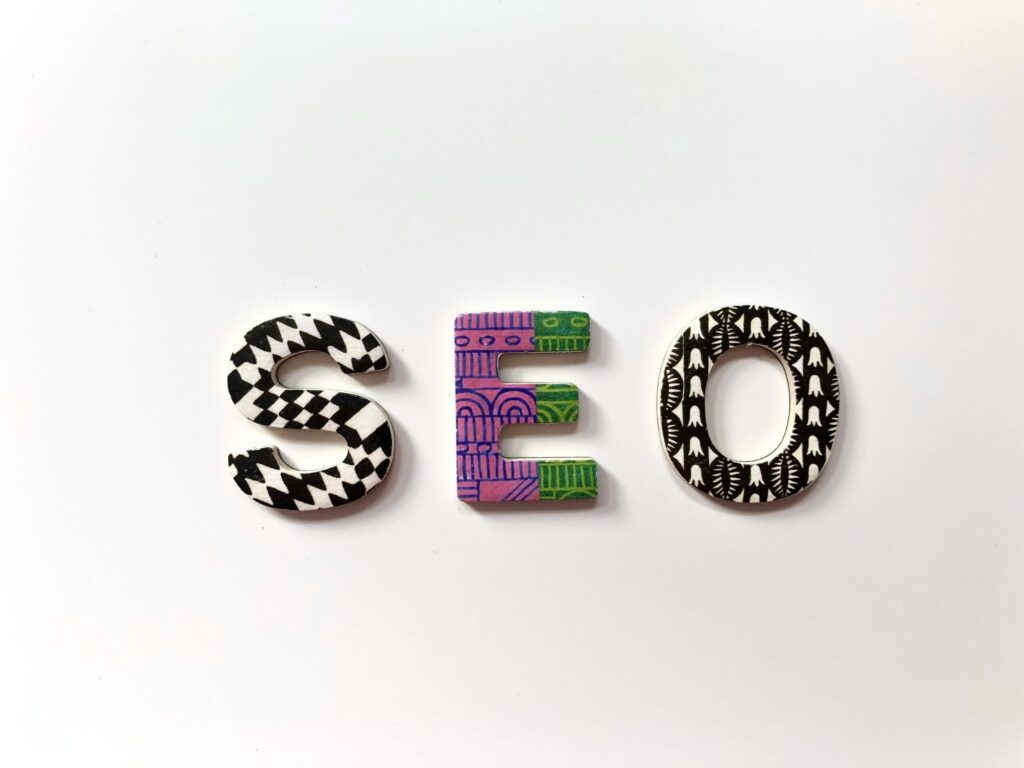 SEO spelled out in decorative, patterned wooden letters on a white background